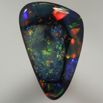 SOLID BLACK OPAL  Unusual pattern, nubular centre surrounded by rolling flashes